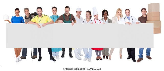 Group of diverse professionals presenting empty banner. Isolated on white