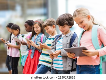 Group of diverse school students using electronic devices against blurred background. school and education concept