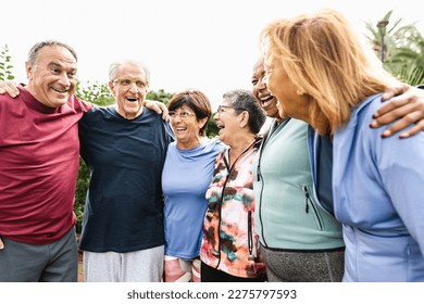 Group of diverse senior friends having fun after workout session at park