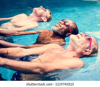 Group Of Diverse Senior Men Enjoying The Pool Together