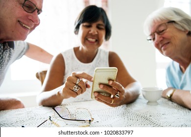 Group Of Diverse Senior People Using Mobile Phone