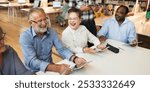 Group of diverse seniors enjoying a tech class. Seniors learning with tablets, smiling, and engaging. Happy seniors in a learning environment. Diverse senior adults in group therapy at library.