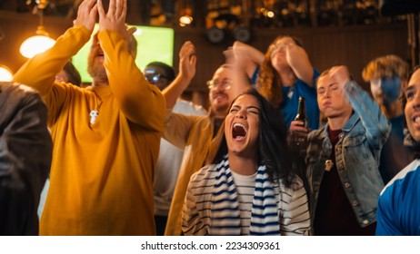 Group of Diverse Soccer Fans Cheering Their Team During a Football Game Live Broadcast in a Sports Pub. Anxious Crowd Saddened and Angry When Competitor Player Scores a Decisive Goal. - Powered by Shutterstock