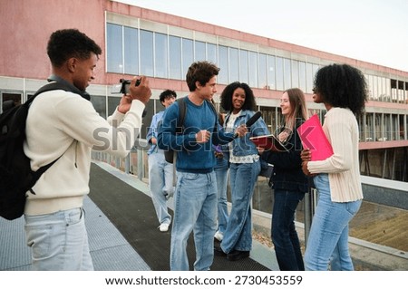 Group of diverse students interviewing a peer, creating content for their social media channel