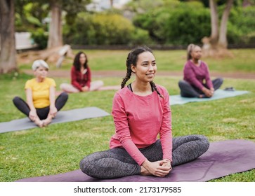 Group of diverse women doing yoga exercise at city park - Powered by Shutterstock