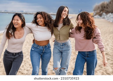 group of diverse women on the beach walking on the sand happy, having fun on the beach - Powered by Shutterstock