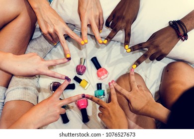 Group of diverse women painting their nails - Powered by Shutterstock