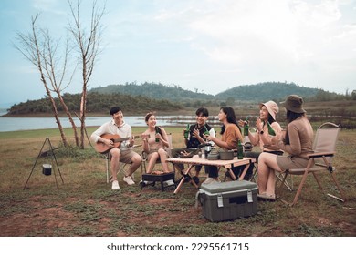 Group of diverse young asian people enjoy bbq and beer camping party in evening at campground, Outdoor lifestyle on vacation summer. - Powered by Shutterstock