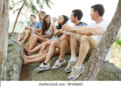 Group Of Diverse Young Hikers Taking A Water Break On A Cliff At Great Falls National Park In Virginia