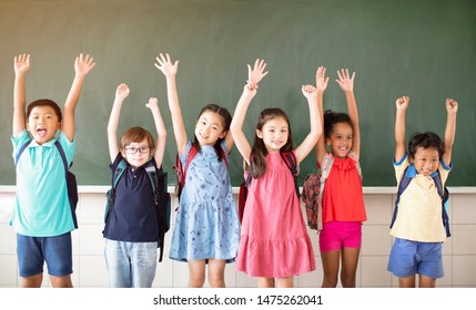 Group Of Diverse Young Students Standing Together In Classroom