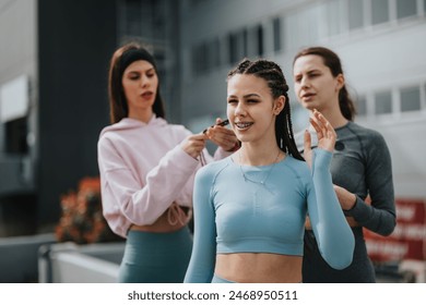 Group of diverse young women in sportswear bonding and preparing for a workout in an urban environment. - Powered by Shutterstock