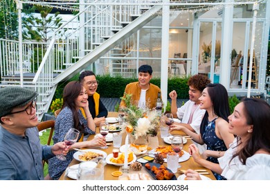 Group Of Diversity Asian Millennial People Friends Enjoy Outdoor Garden Dinner Party Eating Food And Drinking Wine With Talking Together. Reunion Friendship Meeting Celebration And Night Life Concept.