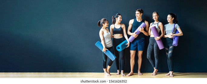 Group Of Diversity Ethnic People Holding Yoga Mat Talking Together With Smile. Asian Girl Laughing With Funny Face After Finish Training Class. Happy And Relax Time In Group Of Friend In Banner Size.