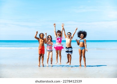 Group of Diversity little child boy and girl friends running and playing sea water at tropical beach together on summer vacation. Happy children kids enjoy and fun outdoor lifestyle on beach holiday.