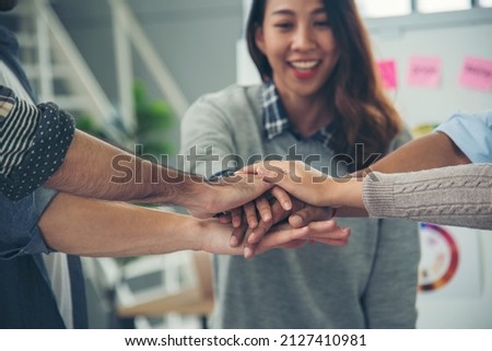 Group of diversity people fist bump holding hands together power of tag team. Teamwork Multiethnic people group working togetherness. Business people team holding hands successful. Business meeting