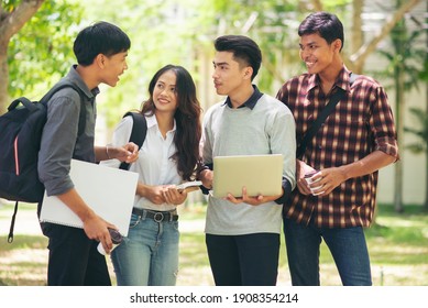 Group Of Diversity Student Talking And Laughing Together At Asian College, Working On Laptop And Smart Phone. Happy Multi Ethnic Friend Successfully Completes The Thesis Report And Passed Final Exam