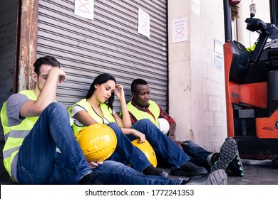 Group Of Diversity Worker Feeling Sad And Stress Due To They Lost Job Due To Covid Virus Pandemic. Factory Warehouse Is Closed To Prevent Infection Between People. Big Economic Impact From Coronavirus