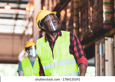 Group Of Diversity Workers (African, Caucasian, Hispanic) In Protective Face Mask And Shield Work In  Warehouse Cargo. Concept Of New Normal Work After Covid 19 Coronavirus Pandemic Outbreak