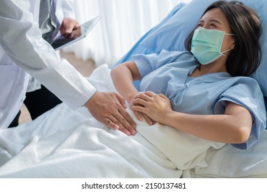 Group Of Doctor Try To Help Patient Woman Lie On Hospital Bed And Holding On Stomach Suffering. Abdominal Pain That Comes From Menstruation, Diarrhea, Or Indigestion. Sickness And Healthcare Concept