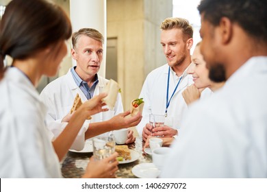 Group Of Doctors In The Cafeteria Or Canteen Eating And Relaxing Small Talk