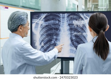 A group of doctors consulting while looking at a screen - Powered by Shutterstock