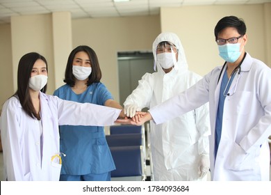 Group Of Doctors Coordinate Hands To Trust. They Are Wearing Face Protective Mask Against Corona Virus ,  Concept Teamwork Healthy And Medical In Hospital.