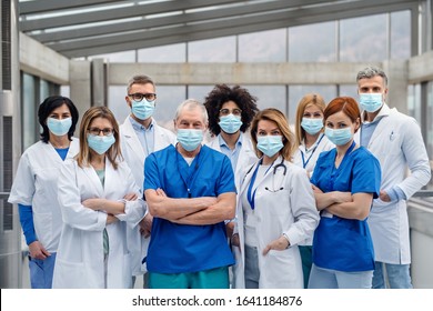 Group of doctors with face masks looking at camera, corona virus concept. - Powered by Shutterstock