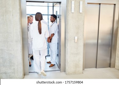 Group of doctors and nurses together in the elevator in the hospital - Powered by Shutterstock