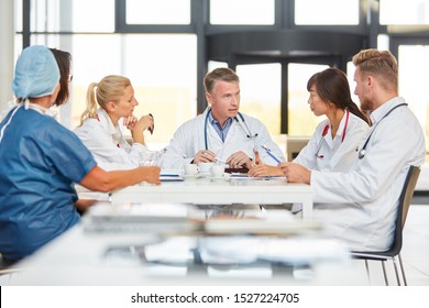 Group of doctors with nurses in training in a team meeting
