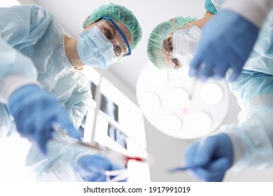 Group of doctors performing surgical operation in clinic. Emergency surgical care concept