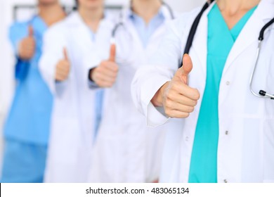 Group Of Doctors Showing OK Or Approval Sign With Thumb Up. High Level And Quality Medical Service, Best Treatment And Patient Care Concept