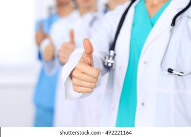 Group Of Doctors Showing OK Or Approval Sign With Thumb Up. High Level And Quality Medical Service, Best Treatment And Patient Care Concept