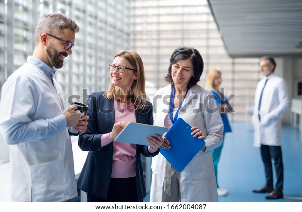 Group of doctors talking to\
pharmaceutical sales\
representative.
