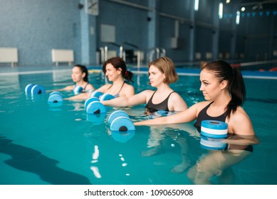 Group doing exercise with dumbbells, aqua aerobics