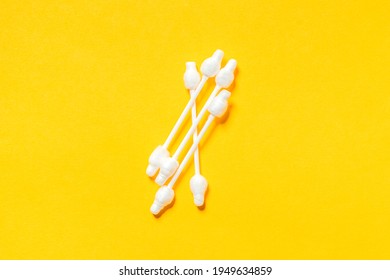 Group Of Eared Sticks With Limiters On Yellow Background. Swab On Stick, Plastic Rod. Cosmetic Tools. Ear Care Concept