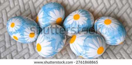 Group of Easter eggs with floral print on light background