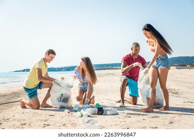 Group of eco volunteers  holding bags with plastic after sorting waste - Friends cleaning the beach and collecting plastic to save marine life - Powered by Shutterstock