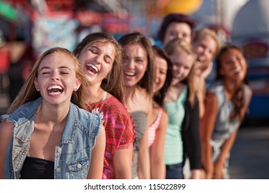 Group Of Eight Girls In A Row Laughing