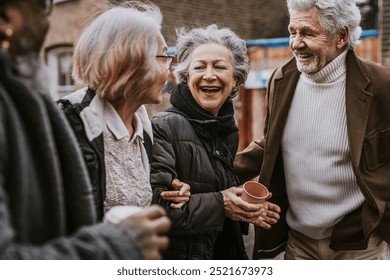 Group of elderly friends, old men and women, enjoying a walk and talking. Elderly friends laughing, elderly friends outdoors, elderly friends bonding. Senior men and women have a good time in the city - Powered by Shutterstock