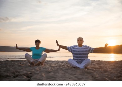 group elderly of people practice Tai Chi Chuan  at sunset on the beach.  Chinese management skill Qi's energy. Healthy lifestyle  - Powered by Shutterstock