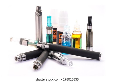 Group of electronic cigarette nicotine inhalator ,bottles with liquids behind the inhalator. isolated on white background