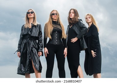 Group Of Elegant People. Fashion Portrait Of Group Fashion Models Girls Posing Outdoor, Black Style Outfit Against Sky. Attractive Young Vogue Women. Stylish Casual Clothes.