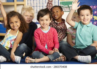 Group Of Elementary Age Schoolchildren Answering Question In Class - Shutterstock ID 280370408