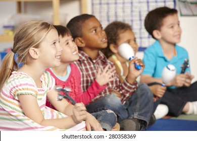 Group Of Elementary Age Schoolchildren In Music Class With Instruments