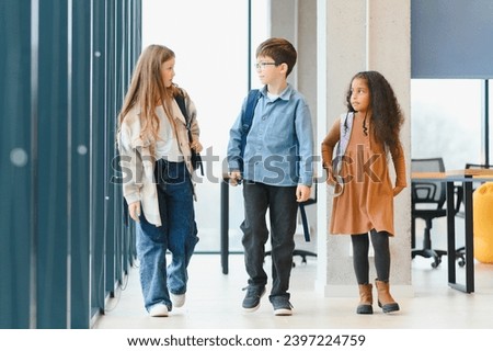 Group of elementary school kids in a school corridor.