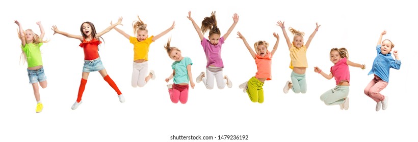 Group Of Elementary School Kids Or Pupils Jumping In Colorful Casual Clothes Jumping Isolated On White Studio Background. Creative Collage. Back To School, Education, Childhood Concept.