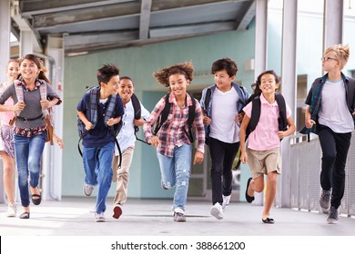 Group Of Elementary School Kids Running In A School Corridor