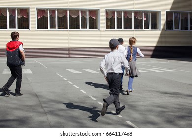 Group Of Elementary School Kids Running At School