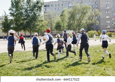 Group Of Elementary School Kids Running At School