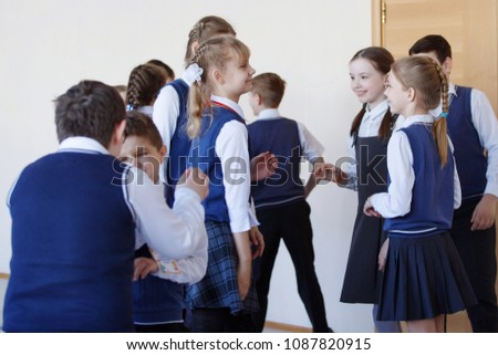 Group of elementary school kids standing in school corridor